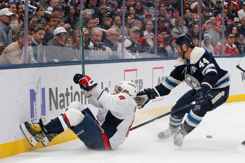 Oct 24, 2025; Columbus, Ohio, USA; Washington Capitals left wing Alex Ovechkin (8) falls to the ice after colliding with Columbus Blue Jackets defenseman Erik Gudbranson (44) during the first period at Nationwide Arena. Mandatory Credit: Russell LaBounty-Imagn Images
