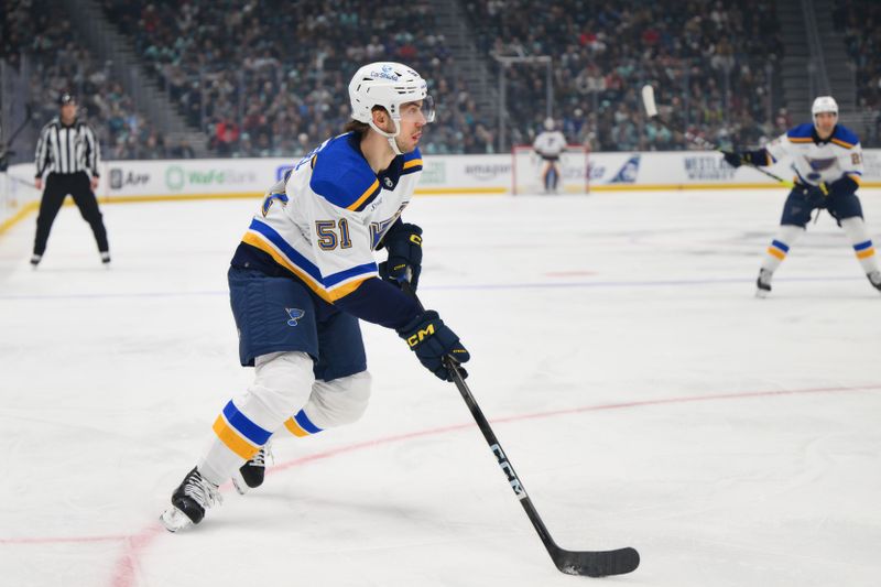 Jan 26, 2024; Seattle, Washington, USA; St. Louis Blues defenseman Matthew Kessel (51) plays the puck against the Seattle Kraken during the first period at Climate Pledge Arena. Mandatory Credit: Steven Bisig-USA TODAY Sports