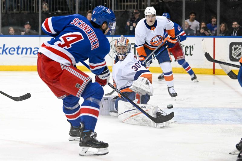 Apr 13, 2024; New York, New York, USA;  New York Rangers defenseman Braden Schneider (4) shoots and scores a goal past New York Islanders goaltender Ilya Sorokin (30) during the second period at Madison Square Garden. Mandatory Credit: Dennis Schneidler-USA TODAY Sports