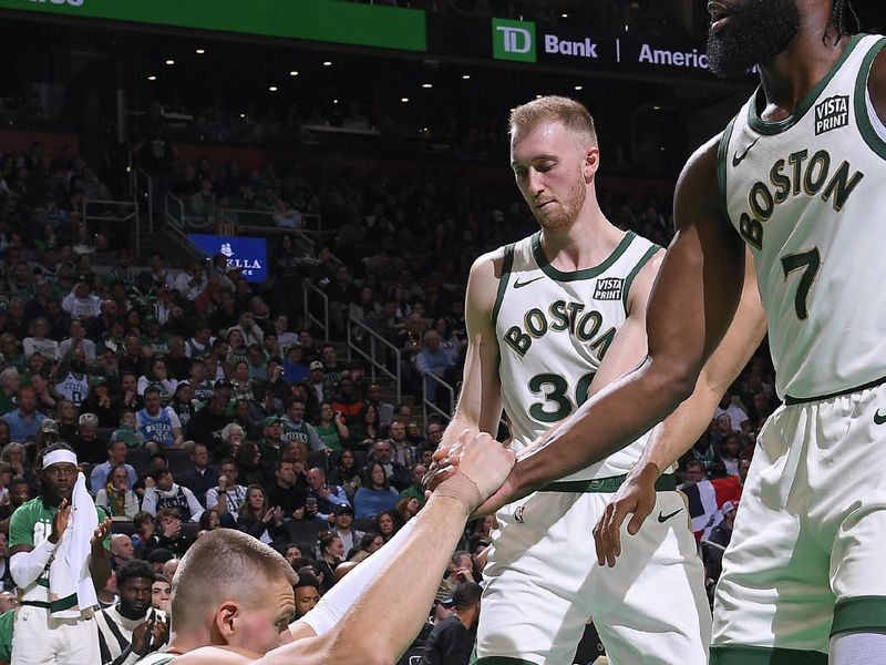 BOSTON, MA - FEBRUARY 27: Jaylen Brown #7 and Sam Hauser #30 of the Boston Celtics help up Kristaps Porzingis #8 during the game against the Philadelphia 76ers on February 27, 2024 at the TD Garden in Boston, Massachusetts. NOTE TO USER: User expressly acknowledges and agrees that, by downloading and or using this photograph, User is consenting to the terms and conditions of the Getty Images License Agreement. Mandatory Copyright Notice: Copyright 2024 NBAE  (Photo by Brian Babineau/NBAE via Getty Images)