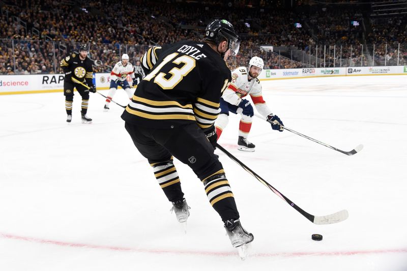 Apr 6, 2024; Boston, Massachusetts, USA; Boston Bruins center Charlie Coyle (13) handles the puck while Florida Panthers defenseman Oliver Ekman-Larsson (91) defends during the first period at TD Garden. Mandatory Credit: Bob DeChiara-USA TODAY Sports