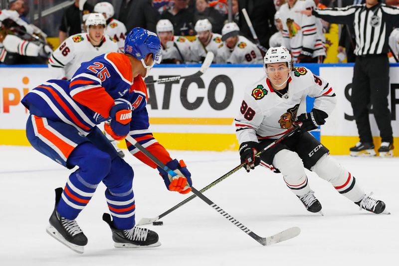 Oct 12, 2024; Edmonton, Alberta, CAN; Chicago Blackhawks forward Connor Bedard (98) looks to make a pass in front of Edmonton Oilers defensemen Darnell Nurse (25) during the second period at Rogers Place. Mandatory Credit: Perry Nelson-Imagn Images