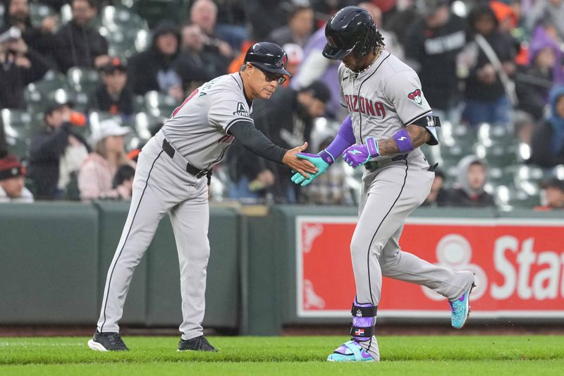 May 10, 2024; Baltimore, Maryland, USA; Arizona Diamondbacks second baseman Ketel Marte (4) greeted by coach Tony Perezchica (21) following a solo home run in the third inning against the Baltimore Orioles at Oriole Park at Camden Yards. Mandatory Credit: Mitch Stringer-USA TODAY Sports