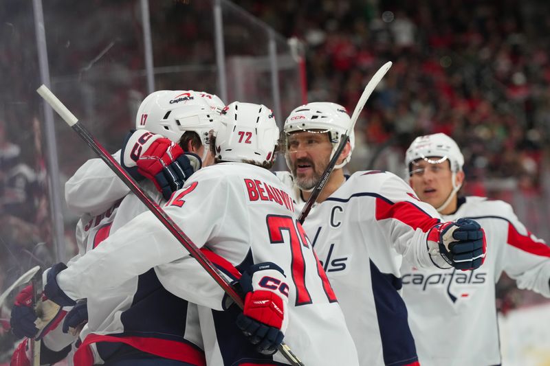 Nov 11, 2025; Raleigh, North Carolina, USA; Washington Capitals center Dylan Strome (17) celebrates his goal with  left wing Anthony Beauvillier (72) and left wing Alex Ovechkin (8) against the Carolina Hurricanes during the second period at Lenovo Center. Mandatory Credit: James Guillory-Imagn Images
