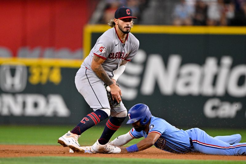 Aug 24, 2025; Arlington, Texas, USA; Texas Rangers second baseman Ezequiel Duran (20) steals second base in front of Cleveland Guardians shortstop Gabriel Arias (13) during the fourth inning at Globe Life Field. Mandatory Credit: Jerome Miron-Imagn Images