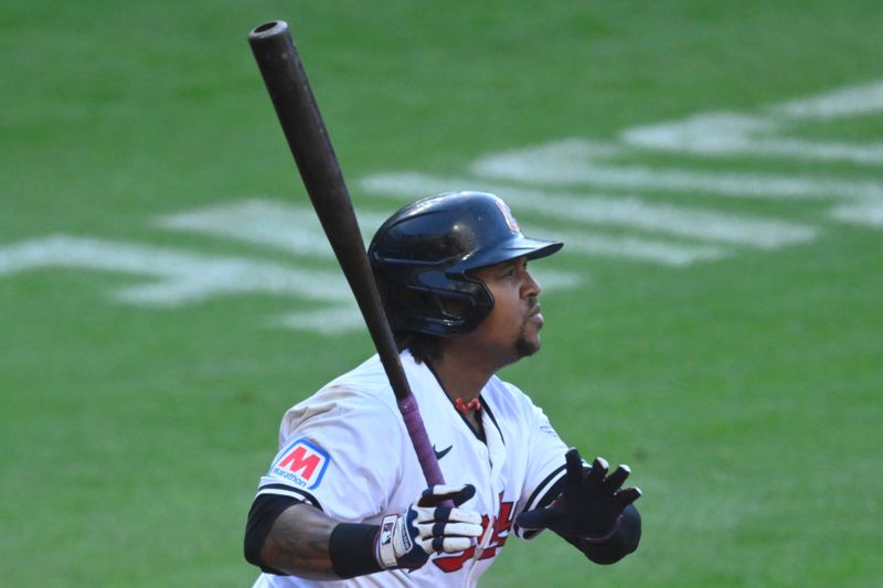 May 18, 2024; Cleveland, Ohio, USA; Cleveland Guardians third baseman Jose Ramirez (11) hits an RBI double in the third inning against the Minnesota Twins at Progressive Field. Mandatory Credit: David Richard-USA TODAY Sports