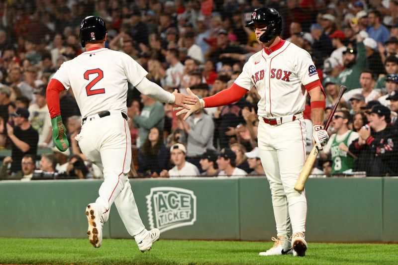 Sep 14, 2025; Boston, Massachusetts, USA;  Boston Red Sox third baseman Alex Bregman (2) high-fives first baseman Romy Gonzalez (23) after scoring a run against the New York Yankees during the first inning at Fenway Park. Mandatory Credit: Brian Fluharty-Imagn Images