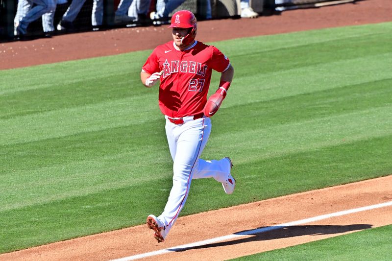 Feb 29, 2024; Tempe, Arizona, USA;  Los Angeles Angels center fielder Mike Trout (27) scores in the fourth inning against the Cleveland Guardians during a spring training game at Tempe Diablo Stadium. Mandatory Credit: Matt Kartozian-USA TODAY Sports