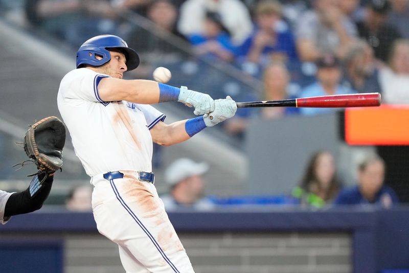 Jun 27, 2024; Toronto, Ontario, CAN; Toronto Blue Jays center fielder Daulton Varsho (25) keeps his eye on the ball  during an at bat against the New York Yankees during the fifth inning at Rogers Centre. Mandatory Credit: John E. Sokolowski-USA TODAY Sports