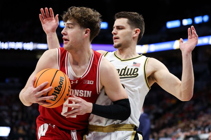 Mar 16, 2024; Minneapolis, MN, USA; Wisconsin Badgers guard Max Klesmit (11) catches a pass as Purdue Boilermakers forward Camden Heide (23) defends during the first half at Target Center. Mandatory Credit: Matt Krohn-USA TODAY Sports