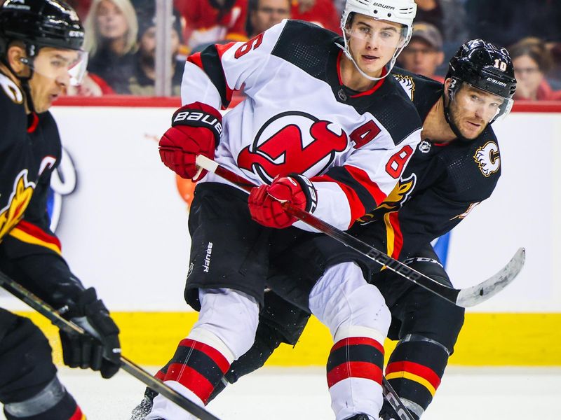 Dec 9, 2023; Calgary, Alberta, CAN; New Jersey Devils center Jack Hughes (86) passes the puck against the Calgary Flames during the third period at Scotiabank Saddledome. Mandatory Credit: Sergei Belski-USA TODAY Sports