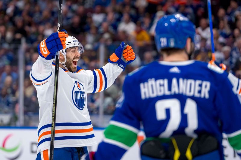 May 20, 2024; Vancouver, British Columbia, CAN; Vancouver Canucks forward Nils Hoglander (21) watches as Edmonton Oilers defenseman Evan Bouchard (2) celebrates his goal during the second period in game seven of the second round of the 2024 Stanley Cup Playoffs at Rogers Arena. Mandatory Credit: Bob Frid-USA TODAY Sports