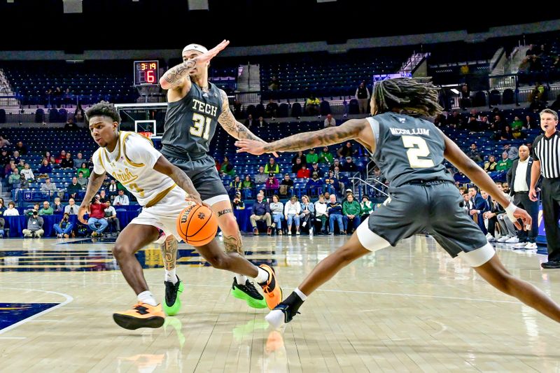 Jan 28, 2025; South Bend, Indiana, USA; Notre Dame Fighting Irish guard Markus Burton (3) dribbles as Georgia Tech Yellow Jackets forward Duncan Powell (31) and guard Javian McCollum (2) defend in the first half at the Purcell Pavilion. Mandatory Credit: Matt Cashore-Imagn Images