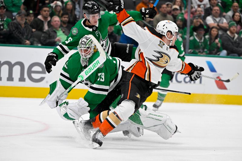 Jan 25, 2024; Dallas, Texas, USA; Dallas Stars defenseman Nils Lundkvist (5) and goaltender Jake Oettinger (29) collide with Anaheim Ducks right wing Frank Vatrano (77) during the third period at the American Airlines Center. Mandatory Credit: Jerome Miron-USA TODAY Sports