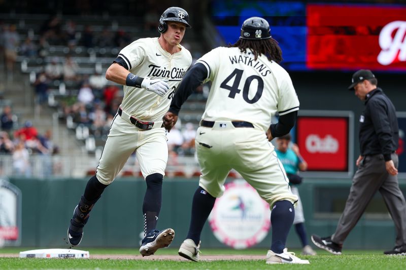 May 9, 2024; Minneapolis, Minnesota, USA; Minnesota Twins designated hitter Max Kepler (26) celebrates his solo home run with third base coach Tommy Watkins (40) during the seventh inning against the Seattle Mariners at Target Field. Mandatory Credit: Matt Krohn-USA TODAY Sports