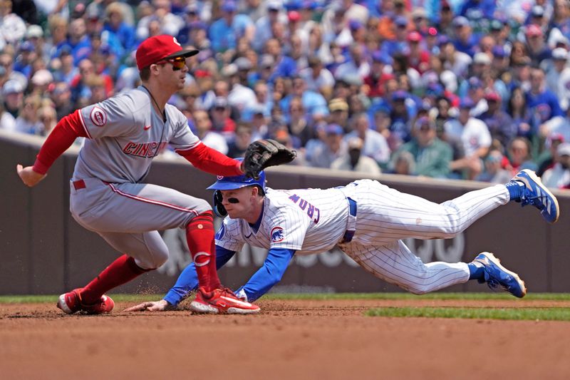 Jun 1, 2025; Chicago, Illinois, USA; Chicago Cubs outfielder Pete Crow-Armstrong (4) steals second base as Cincinnati Reds second base Matt McLain (9) takes a late throw during the first inning at Wrigley Field. Mandatory Credit: David Banks-Imagn Images
