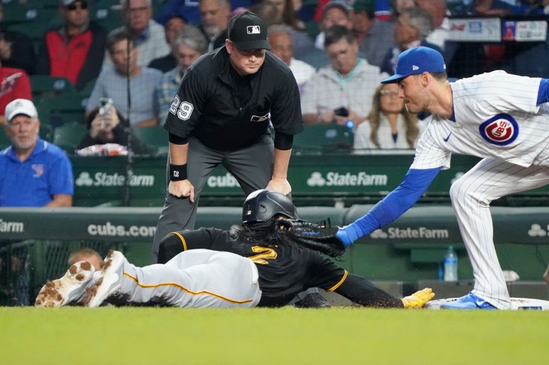 Sep 21, 2023; Chicago, Illinois, USA; Pittsburgh Pirates designated hitter Connor Joe (2) slides safely into first base as Chicago Cubs first baseman Cody Bellinger (24) applies a tag during the first inning at Wrigley Field. Mandatory Credit: David Banks-USA TODAY Sports