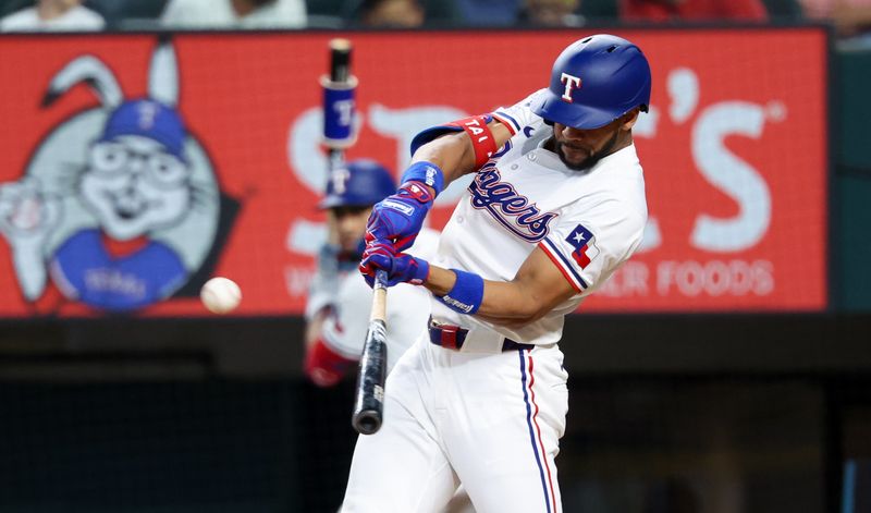 Jul 2, 2024; Arlington, Texas, USA;  Texas Rangers center fielder Leody Taveras (3) hits an rbi double during the second inning against the San Diego Padres at Globe Life Field. Mandatory Credit: Kevin Jairaj-USA TODAY Sports