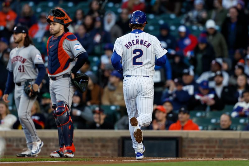 Apr 24, 2024; Chicago, Illinois, USA; Chicago Cubs second baseman Nico Hoerner (2) scores against the Houston Astros during the first inning at Wrigley Field. Mandatory Credit: Kamil Krzaczynski-USA TODAY Sports
