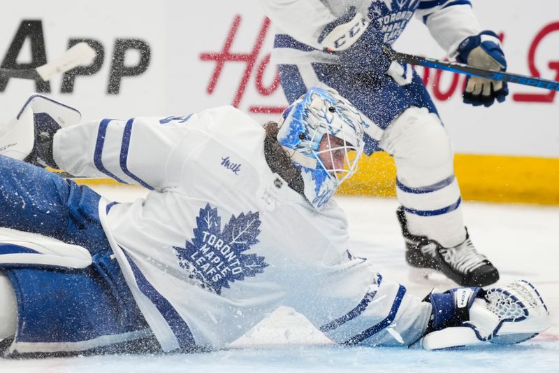 Oct 22, 2024; Columbus, Ohio, USA; Toronto Maple Leafs goaltender Dennis Hildeby (35) dives to cover the puck against the Columbus Blue Jackets during the second period at Nationwide Arena. Mandatory Credit: Aaron Doster-Imagn Images