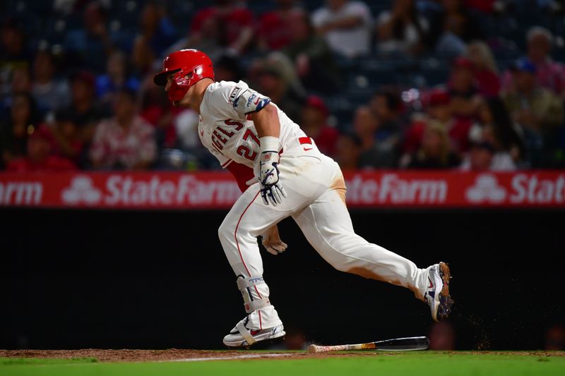 Sep 9, 2025; Anaheim, California, USA; Los Angeles Angels designated hitter Mike Trout (27) runs after hitting a single against the Minnesota Twins during the fifth inning at Angel Stadium. Mandatory Credit: Gary A. Vasquez-Imagn Images