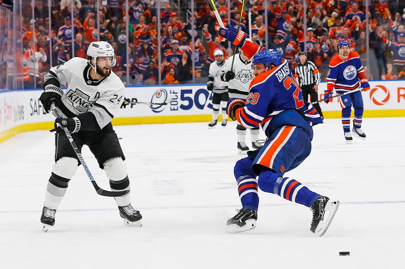 May 1, 2024; Edmonton, Alberta, CAN; Los Angeles Kings forward Phillip Danault (24) hooks Edmonton Oilers forward Leon Draisaitl (29) during the third period in game five of the first round of the 2024 Stanley Cup Playoffs at Rogers Place. Mandatory Credit: Perry Nelson-USA TODAY Sports