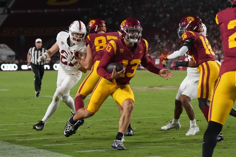 Sep 9, 2023; Los Angeles, California, USA; Southern California Trojans quarterback Caleb Williams (13) scores on a 21-yard touchdown run against the Stanford Cardinal in the first half at United Airlines Field at Los Angeles Memorial Coliseum. Mandatory Credit: Kirby Lee-USA TODAY Sports