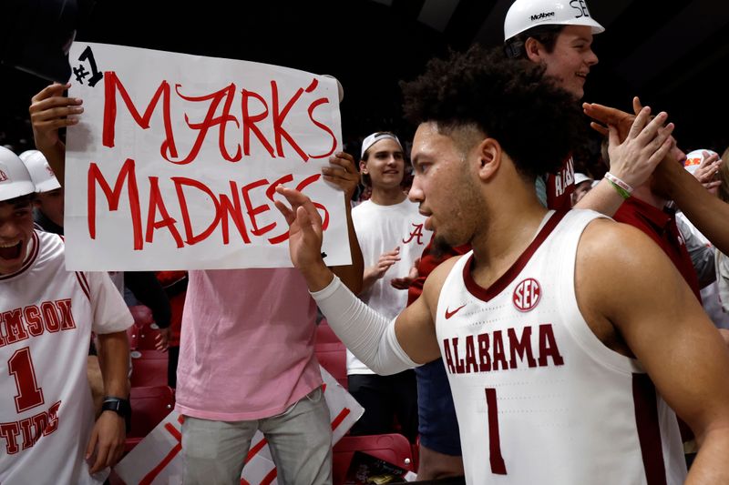 Feb 21, 2024; Tuscaloosa, Alabama, USA; Alabama Crimson Tide guard Mark Sears (1) celebrates with fans after they beat the Florida Gators in overtime at Coleman Coliseum. Mandatory Credit: Butch Dill-USA TODAY Sports