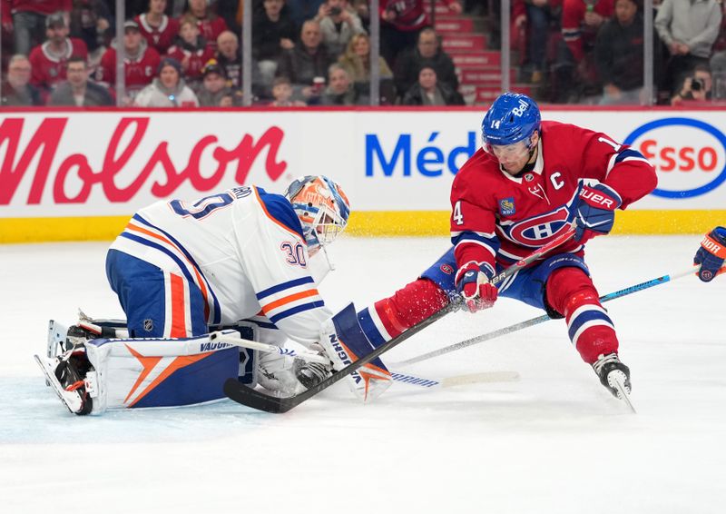 Dec 14, 2025; Montreal, Quebec, CAN; Edmonton Oilers goalie Calvin Pickard (30) defends the net against Montreal Canadiens forward Nick Suzuki (14) during the second period at the Bell Centre. Mandatory Credit: Eric Bolte-Imagn Images