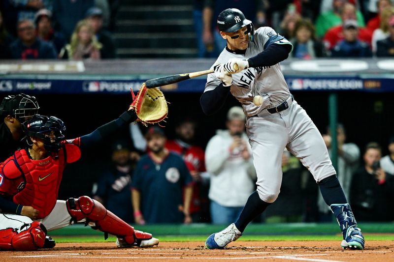 Oct 19, 2024; Cleveland, Ohio, USA; New York Yankees outfielder Aaron Judge (99) is hit by a pitch during the first inning against the Cleveland Guardians during game five of the ALCS for the 2024 MLB playoffs at Progressive Field. Mandatory Credit: David Dermer-Imagn Images