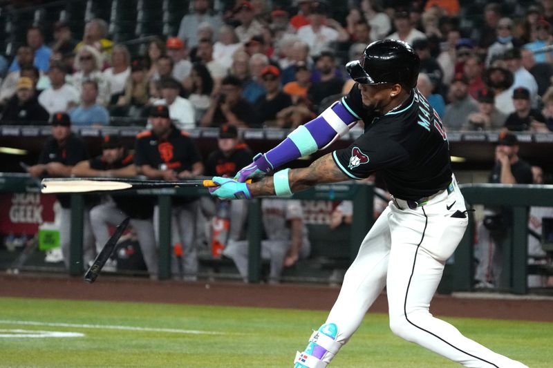Sep 17, 2025; Phoenix, Arizona, USA; Arizona Diamondbacks second base Ketel Marte (4) hits against the San Francisco Giants in the first inning at Chase Field. Mandatory Credit: Rick Scuteri-Imagn Images
