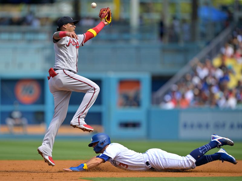 Sep 3, 2023; Los Angeles, California, USA; Los Angeles Dodgers shortstop Chris Taylor (3) slides safely under Atlanta Braves shortstop Orlando Arcia (11) in the third inning at Dodger Stadium. Mandatory Credit: Jayne Kamin-Oncea-USA TODAY Sports