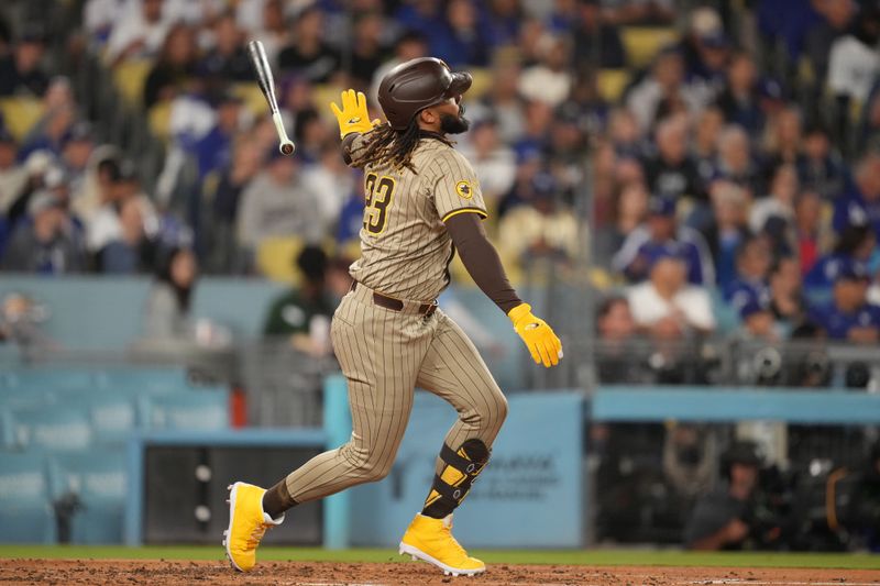 Sep 25, 2024; Los Angeles, California, USA;  San Diego Padres right fielder Fernando Tatis Jr. (23) hits a double in the third inning against the Los Angeles Dodgers at Dodger Stadium. Mandatory Credit: Kirby Lee-Imagn Images