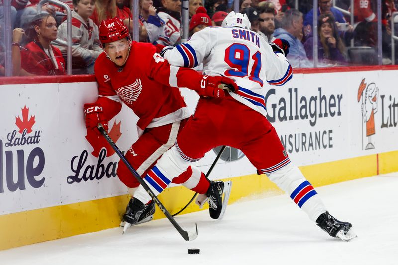 Oct 17, 2024; Detroit, Michigan, USA;  Detroit Red Wings right wing Jonatan Berggren (48) and New York Rangers right wing Reilly Smith (91) battle for the puck in the second period at Little Caesars Arena. Mandatory Credit: Rick Osentoski-Imagn Images