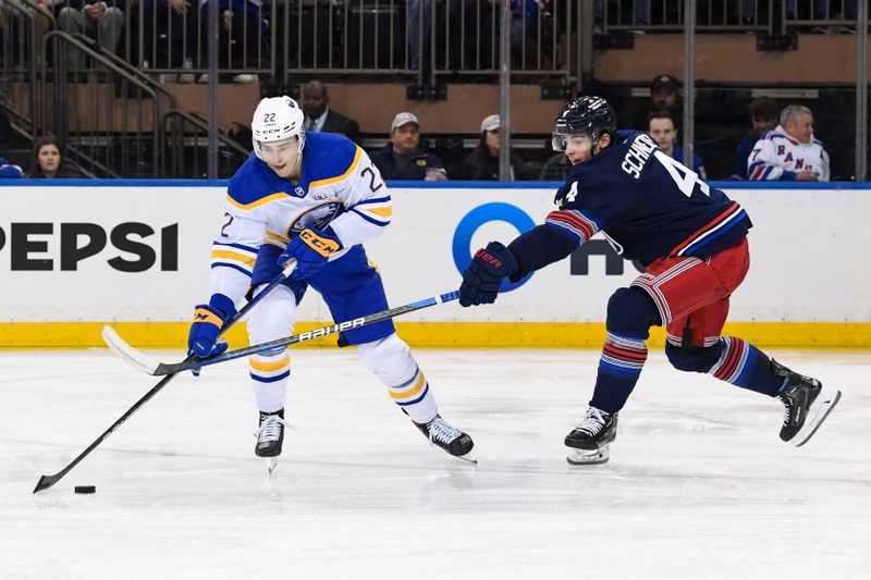 Dec 23, 2023; New York, New York, USA; Buffalo Sabres right wing Jack Quinn (22) takes a shot defended by New York Rangers defenseman Braden Schneider (4) during the second period at Madison Square Garden. Mandatory Credit: Dennis Schneidler-USA TODAY Sports