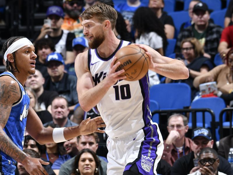 ORLANDO, FL - MARCH 23: Domantas Sabonis #10 of the Sacramento Kings handles the ball against Paolo Banchero #5 of the Orlando Magic during the game on March 23, 2024 at the Kia Center in Orlando, Florida. NOTE TO USER: User expressly acknowledges and agrees that, by downloading and or using this photograph, User is consenting to the terms and conditions of the Getty Images License Agreement. Mandatory Copyright Notice: Copyright 2024 NBAE (Photo by Fernando Medina/NBAE via Getty Images)