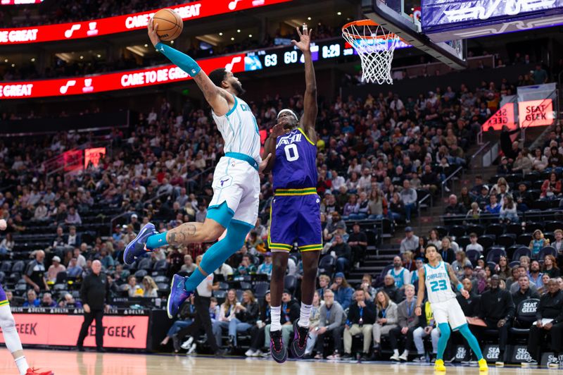 SALT LAKE CITY, UT - FEBRUARY 22:  Miles Bridges #0 of the Charlotte Hornets slam dunks over Taylor Hendricks #0 during the second half of their game at the Delta Center on February 22, 2024 in Salt Lake City, Utah.  NOTE TO USER: User expressly acknowledges and agrees that, by downloading and or using this Photograph, User is concenting to the terms and conditions of the Getty Images license Agreement. (Photo by Chris Gardner/Getty Images)