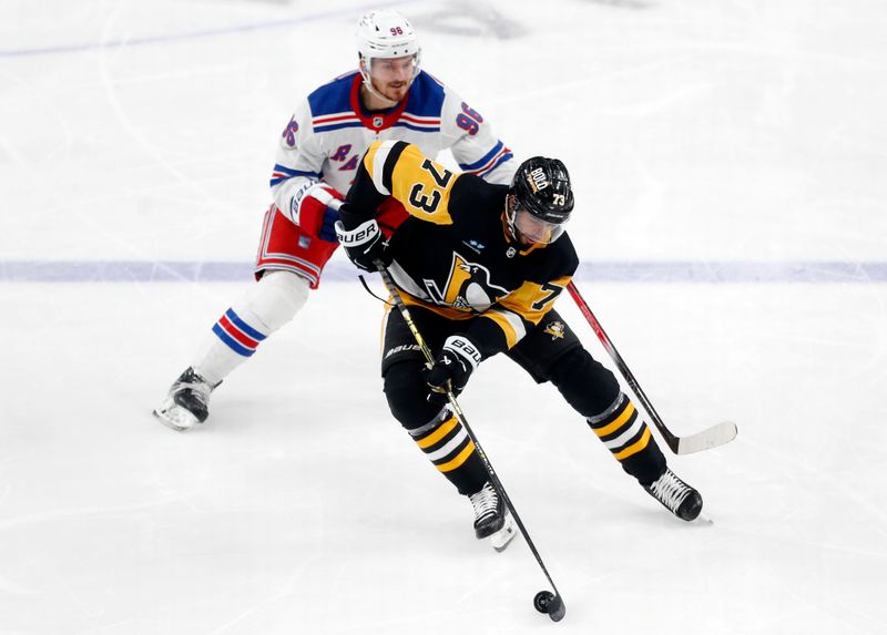 Mar 16, 2024; Pittsburgh, Pennsylvania, USA;  Pittsburgh Penguins defenseman Pierre-Olivier Joseph (73) moves the puck against New York Rangers center Jack Roslovic (96) during the third period at PPG Paints Arena.  New York won 7-4. Mandatory Credit: Charles LeClaire-USA TODAY Sports