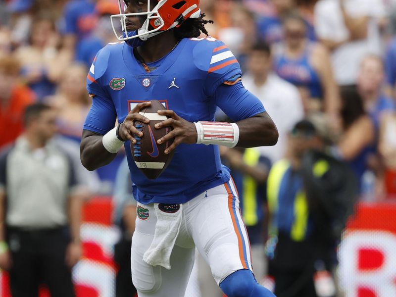 Sep 18, 2021; Gainesville, Florida, USA; Florida Gators quarterback Emory Jones (5) runs out of the pocket against the Alabama Crimson Tide during the first quarter at Ben Hill Griffin Stadium. Mandatory Credit: Kim Klement-USA TODAY Sports