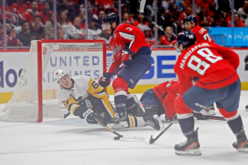 Nov 8, 2024; Washington, District of Columbia, USA; Pittsburgh Penguins right wing Rickard Rakell (67) reaches for a rebound after a save by Washington Capitals goaltender Charlie Lindgren (79) in the second period at Capital One Arena. Mandatory Credit: Geoff Burke-Imagn Images