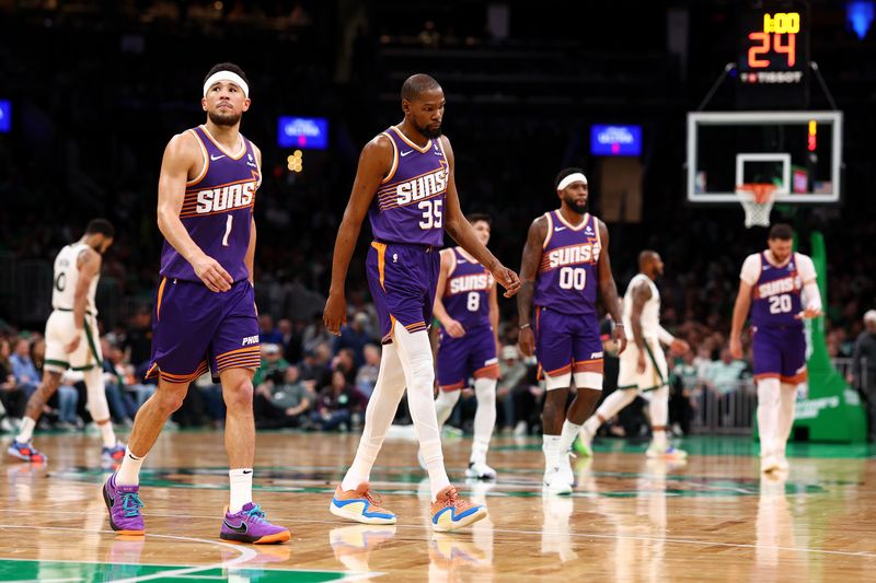 BOSTON, MASSACHUSETTS - MARCH 14: Devin Booker #1 of the Phoenix Suns and Kevin Durant #35 walk off the court during a timeout in the second half against the Boston Celtics at TD Garden on March 14, 2024 in Boston, Massachusetts. The Celtics defeat the Suns 127-112. NOTE TO USER: User expressly acknowledges and agrees that, by downloading and or using this photograph, user is consenting to the terms and conditions of the Getty Images License Agreement.  (Photo by Maddie Meyer/Getty Images)