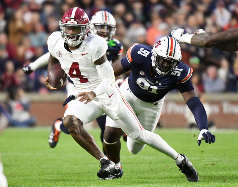 Nov 25, 2023; Auburn, Alabama, USA;  Alabama Crimson Tide quarterback Jalen Milroe (4) scrambles away from Auburn Tigers defensive lineman Zykeivous Walker (91) at Jordan-Hare Stadium. Alabama won 27-24. Mandatory Credit: Gary Cosby Jr.-USA TODAY Sports