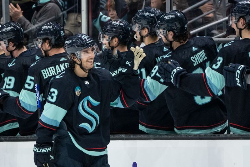 Jan 24, 2024; Seattle, Washington, USA; Seattle Kraken forward Brandon Tanev (13) is congratulated by teammates on the bench after scoring a goal during the second period against the Chicago Blackhawks at Climate Pledge Arena. Mandatory Credit: Stephen Brashear-USA TODAY Sports