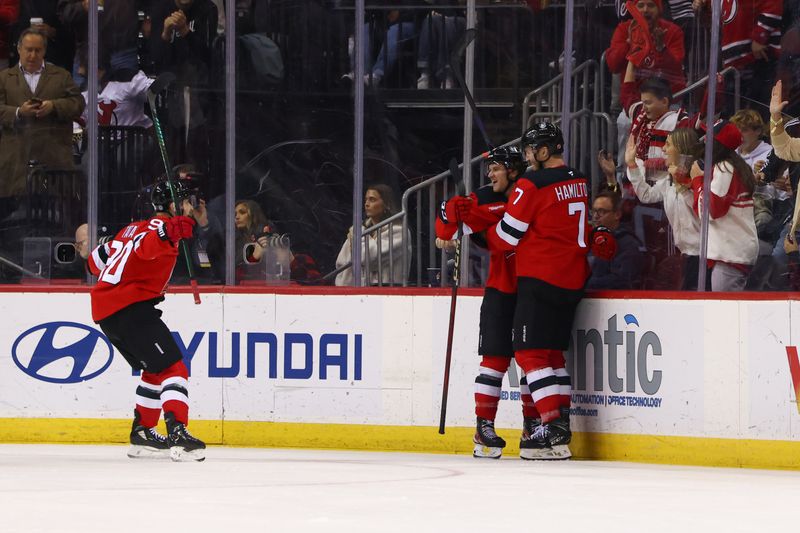 Nov 21, 2024; Newark, New Jersey, USA; New Jersey Devils defenseman Dougie Hamilton (7) celebrates his goal against the Carolina Hurricanes during the third period at Prudential Center. Mandatory Credit: Ed Mulholland-Imagn Images