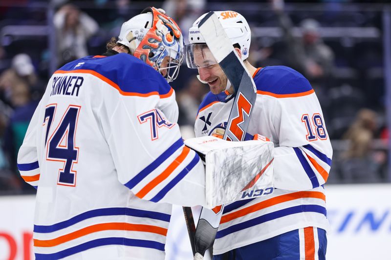 Nov 29, 2025; Seattle, Washington, USA; Edmonton Oilers left wing Zach Hyman (18) celebrates with goalie Stuart Skinner (74) after defeating the Seattle Kraken at Climate Pledge Arena. Mandatory Credit: Kevin Ng-Imagn Images