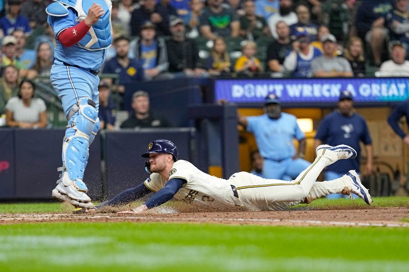 Jun 10, 2024; Milwaukee, Wisconsin, USA;  Milwaukee Brewers second baseman Brice Turang (2) slides into home plate to score a run during the sixth inning against the Toronto Blue Jays at American Family Field. Mandatory Credit: Jeff Hanisch-USA TODAY Sports