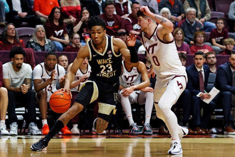 Mar 2, 2024; Blacksburg, Virginia, USA; Wake Forest Demon Deacons guard Hunter Sallis (23) drives to the basket Virginia Tech Hokies guard Hunter Cattoor (0) during the first half at Cassell Coliseum. Mandatory Credit: Peter Casey-USA TODAY Sports