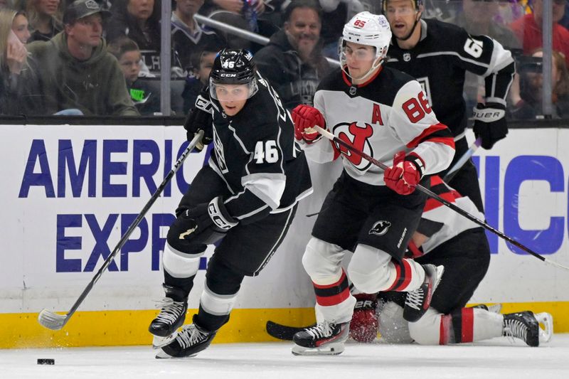 Mar 3, 2024; Los Angeles, California, USA;  Los Angeles Kings center Blake Lizotte (46) skates the puck away from New Jersey Devils center Jack Hughes (86) in the second period at Crypto.com Arena. Mandatory Credit: Jayne Kamin-Oncea-USA TODAY Sports