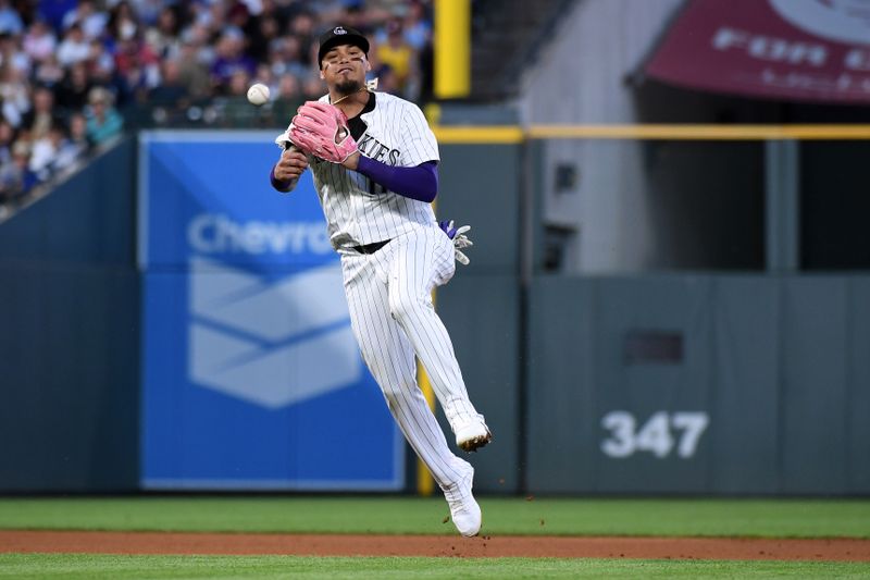 Jun 25, 2025; Denver, Colorado, USA; Colorado Rockies shortstop Orlando Arcia (11) throws to first for an out during the fifth inning against the Los Angeles Dodgers at Coors Field. Mandatory Credit: Christopher Hanewinckel-Imagn Images