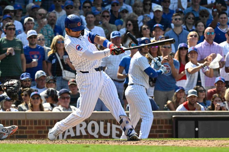 Jul 21, 2024; Chicago, Illinois, USA;  Chicago Cubs outfielder Seiya Suzuki (27) hits an RBI single against the Arizona Diamondbacks during the ninth inning at Wrigley Field. Mandatory Credit: Matt Marton-USA TODAY Sports